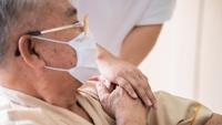 Male patient holding the hand of another person